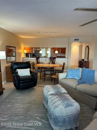 a living room with furniture and a lamp