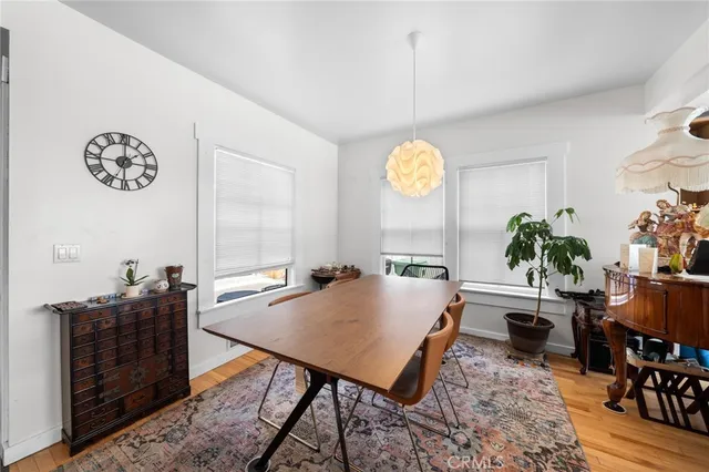 a living room with a table and a potted plant