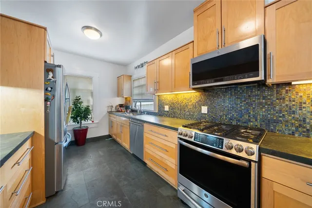 a kitchen with a stove microwave and cabinets