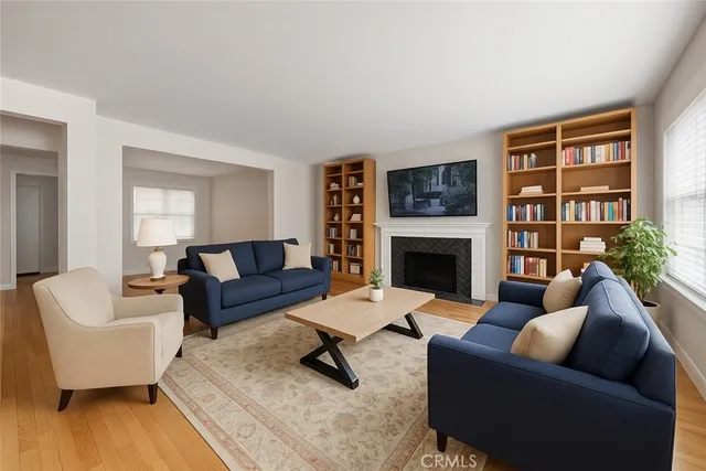 a living room with furniture flat screen tv and a fireplace