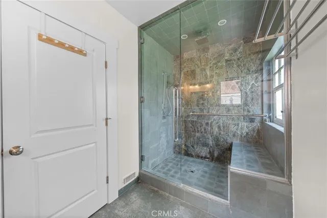 a bathroom with a glass shower door