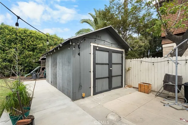 a backyard of a house with wooden fence and trees