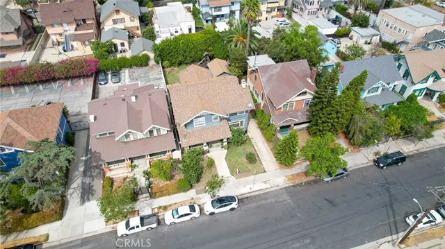 an aerial view of a house with garden space and street view