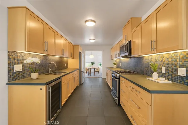 a kitchen with stainless steel appliances granite countertop a sink and stove