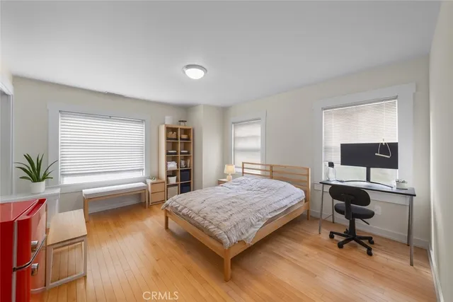 a bedroom with a bed and a desk in it