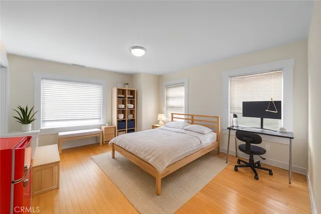 a bedroom with a bed and a desk