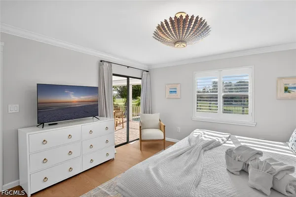 a bedroom with furniture and flat screen tv