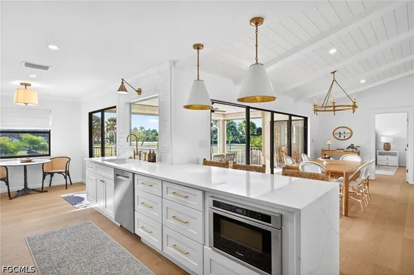a open kitchen with sink a stove and chairs