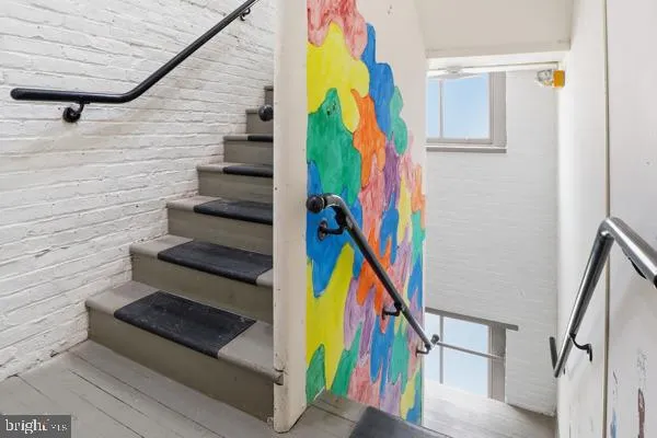 a utility room with dryer washer and stair