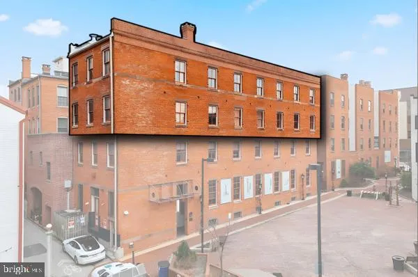 a view of a door with brick wall and a wall