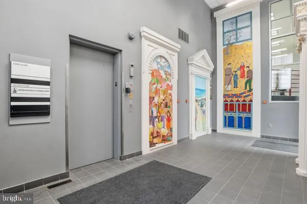 a view of an entryway with wooden floor
