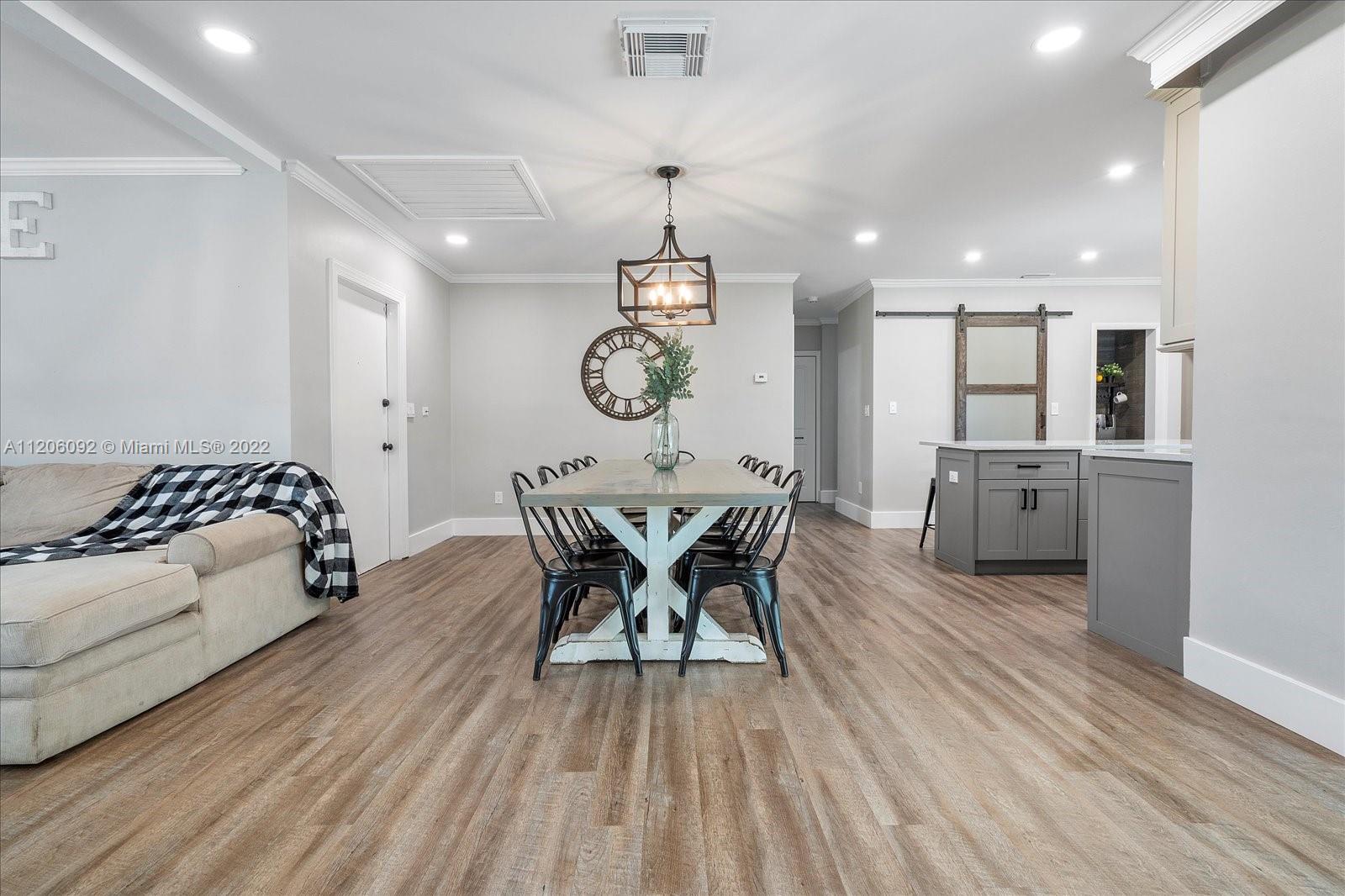 17300 Southwest 294th Street Homestead, FL 33030 - Photo 15 of 50 a view of a dining room with furniture window and wooden floor