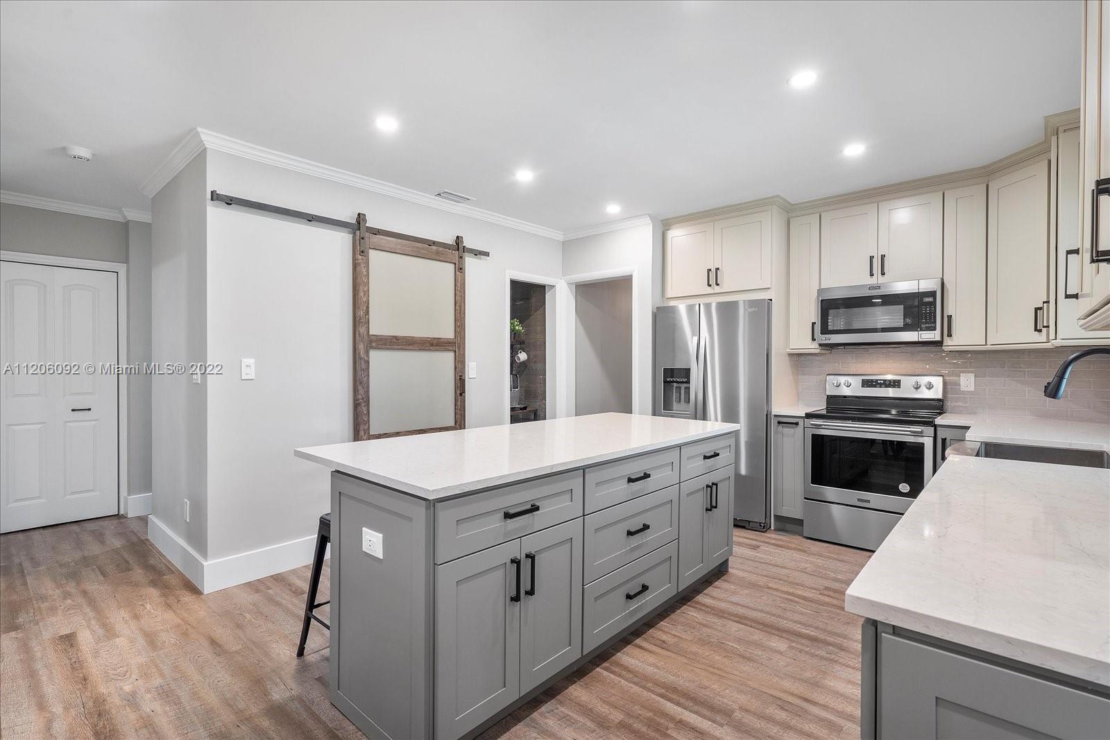 17300 Southwest 294th Street Homestead, FL 33030 - Photo 16 of 50 a kitchen with stainless steel appliances kitchen island granite countertop a stove a sink a refrigerator and a oven