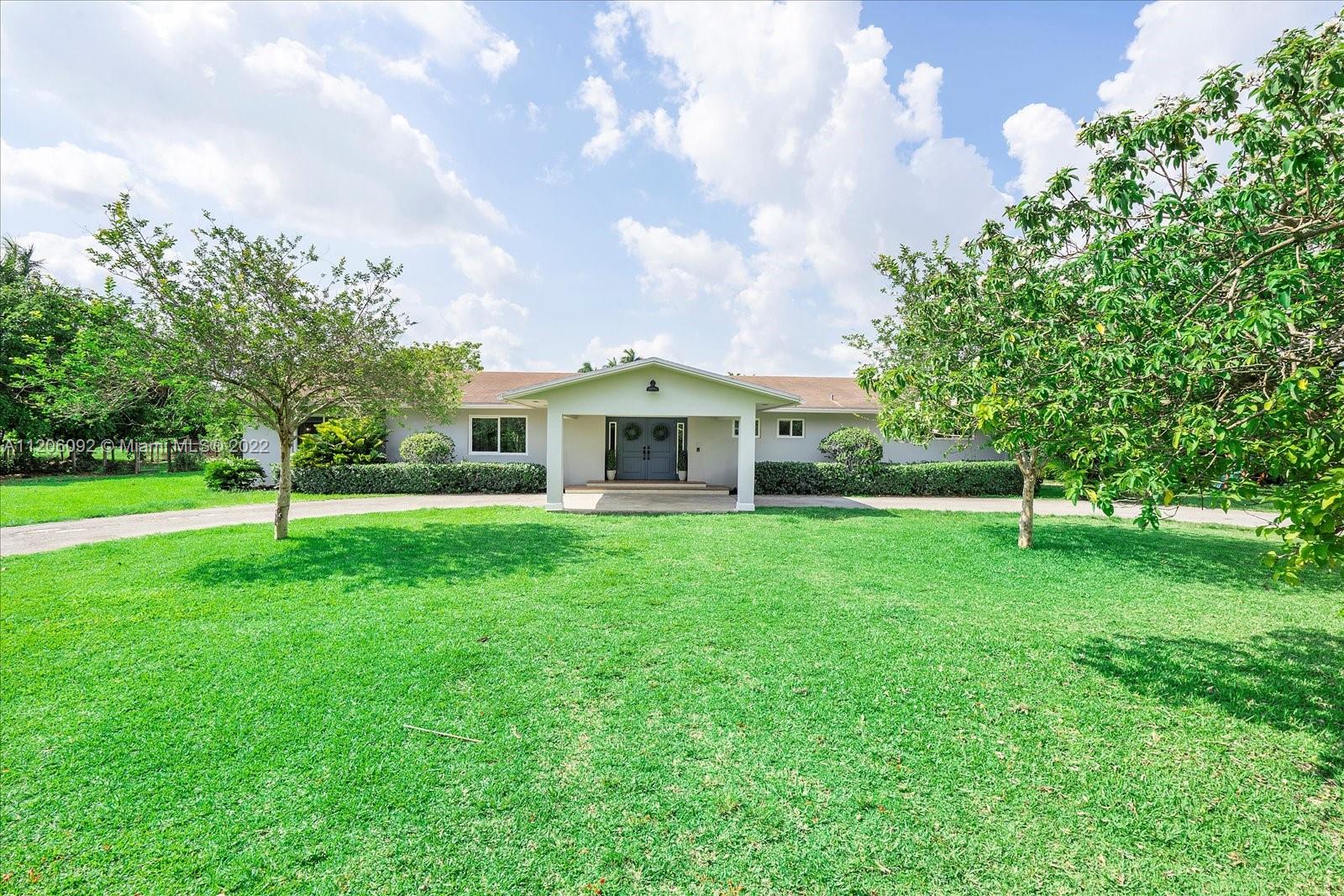 17300 Southwest 294th Street Homestead, FL 33030 - Photo 2 of 50 a front view of a house with a yard
