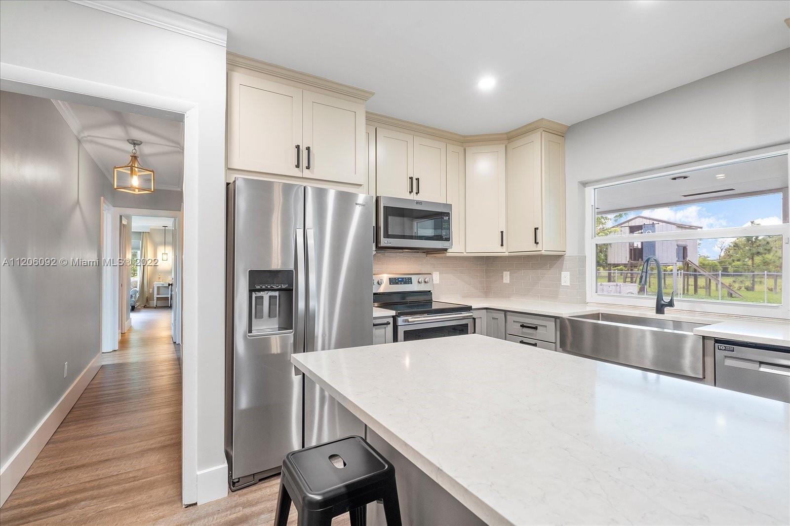 17300 Southwest 294th Street Homestead, FL 33030 - Photo 21 of 50 a kitchen with granite countertop a center island stainless steel appliances and cabinets