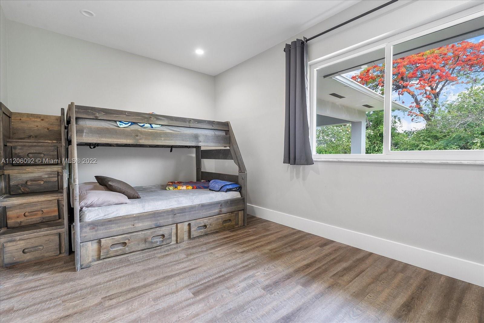 17300 Southwest 294th Street Homestead, FL 33030 - Photo 22 of 50 a bedroom with a bunk bed and a window