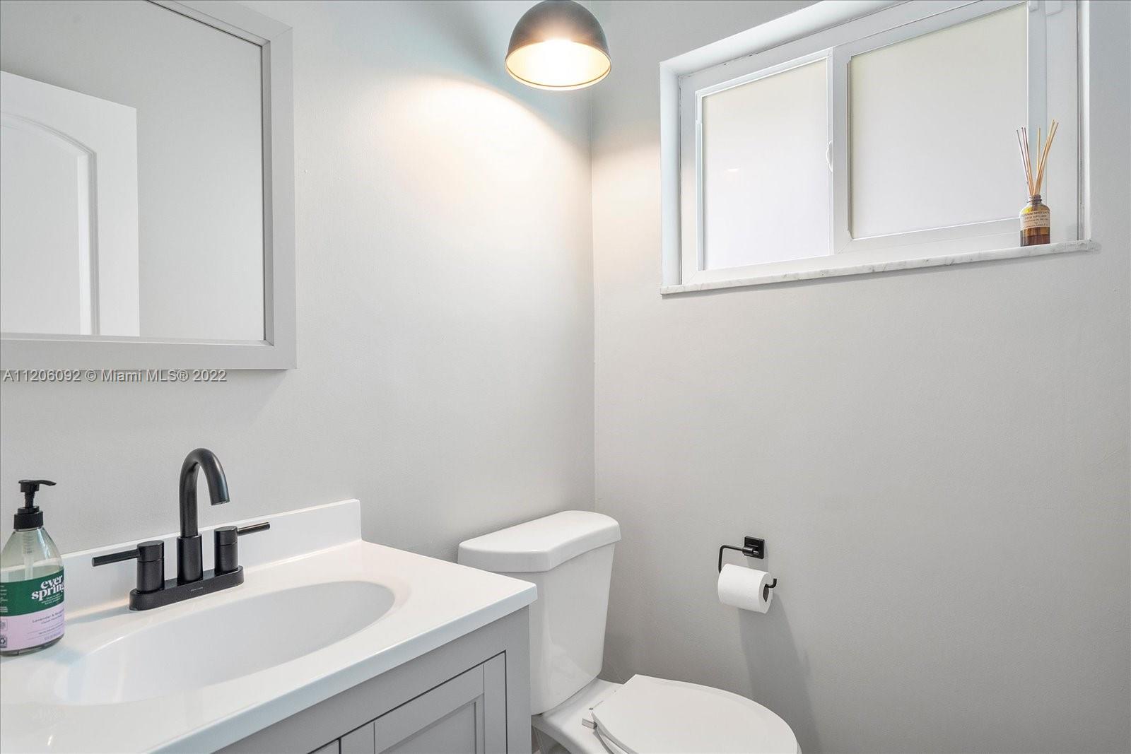 17300 Southwest 294th Street Homestead, FL 33030 - Photo 24 of 50 a bathroom with a toilet sink and mirror