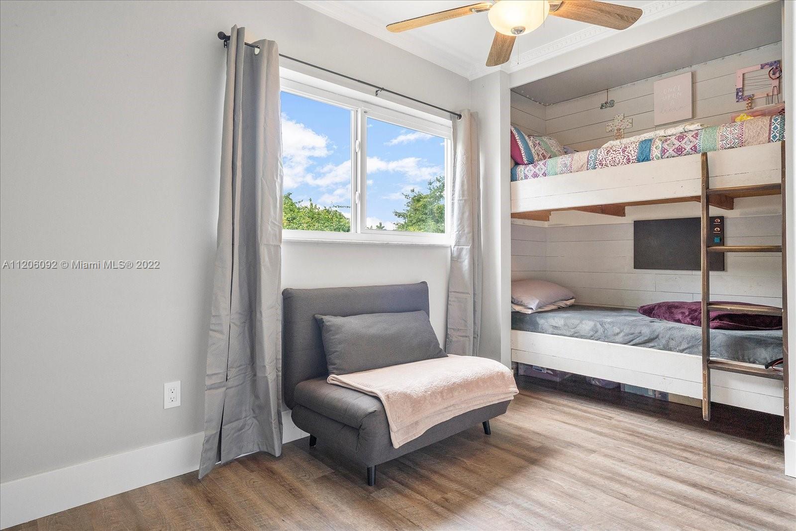 17300 Southwest 294th Street Homestead, FL 33030 - Photo 26 of 50 a bedroom with a bed and a large window