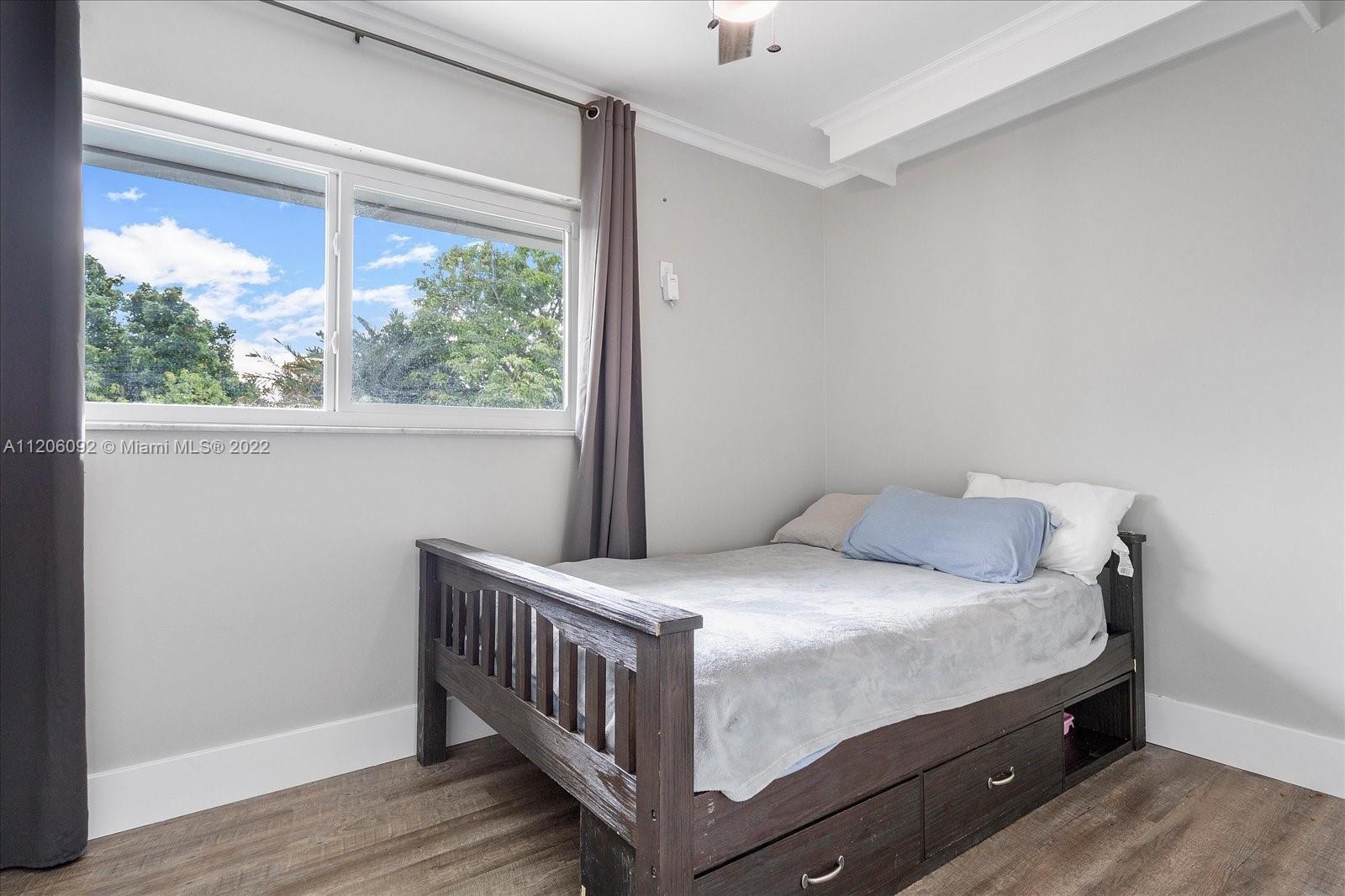 17300 Southwest 294th Street Homestead, FL 33030 - Photo 28 of 50 a room with a bed and a window