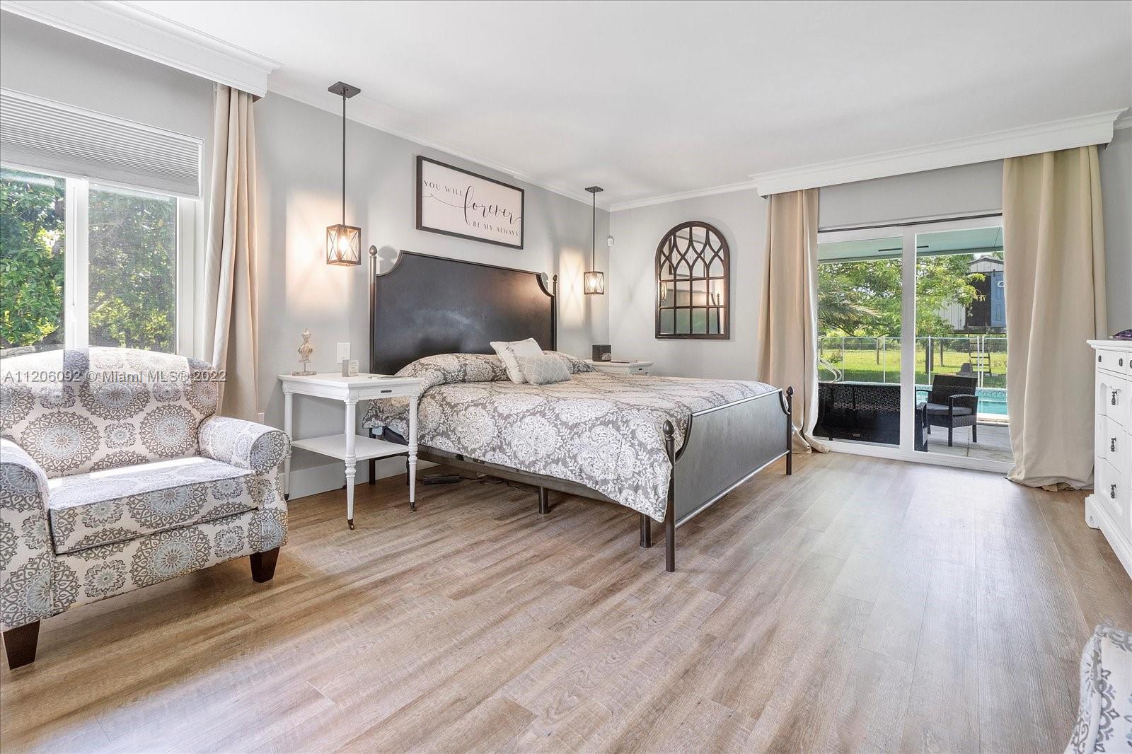 17300 Southwest 294th Street Homestead, FL 33030 - Photo 29 of 50 a bedroom with a bed and a large window