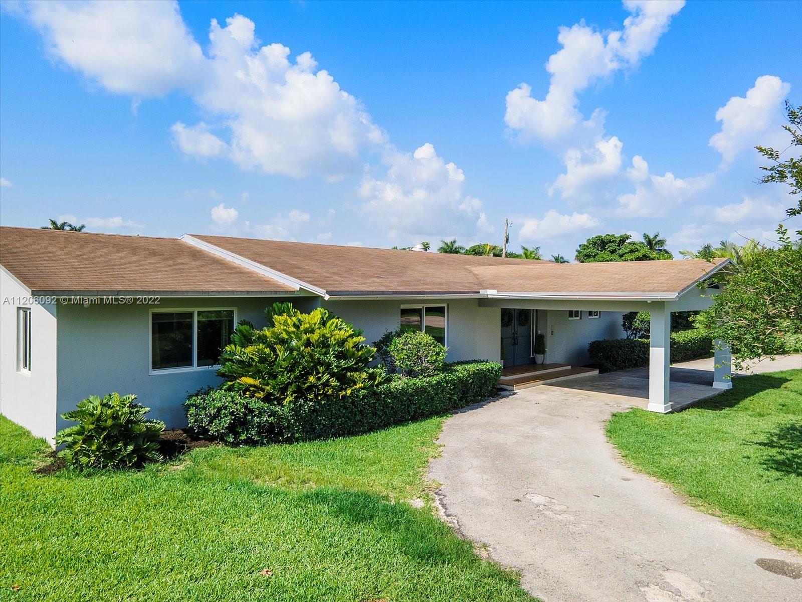 17300 Southwest 294th Street Homestead, FL 33030 - Photo 3 of 50 a front view of a house with garden