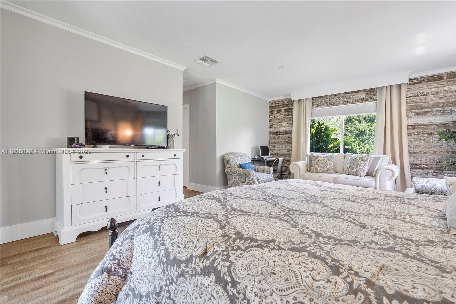 17300 Southwest 294th Street Homestead, FL 33030 - Photo 32 of 50 a bedroom with a bed and a flat screen tv