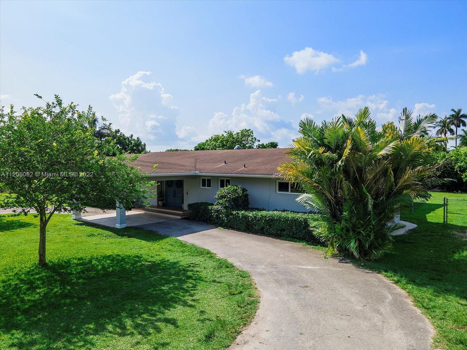 17300 Southwest 294th Street Homestead, FL 33030 - Photo 4 of 50 a front view of a house with garden