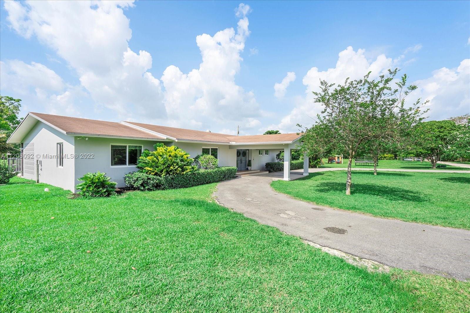17300 Southwest 294th Street Homestead, FL 33030 - Photo 6 of 50 a front view of house with yard and green space