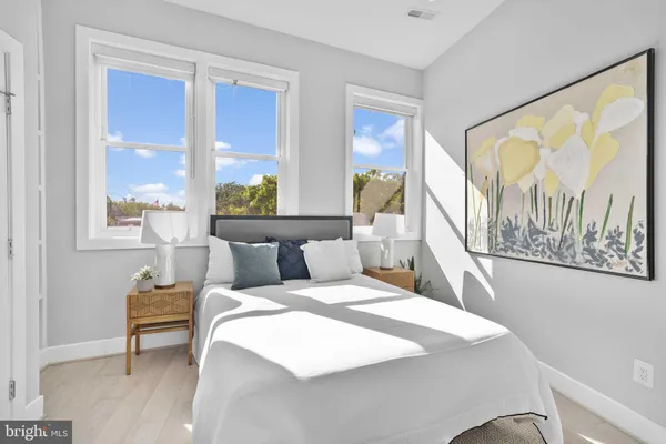 a bedroom with a bed and a large window with outer view