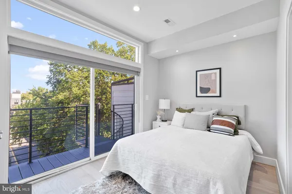 a bedroom with a bed and glass window