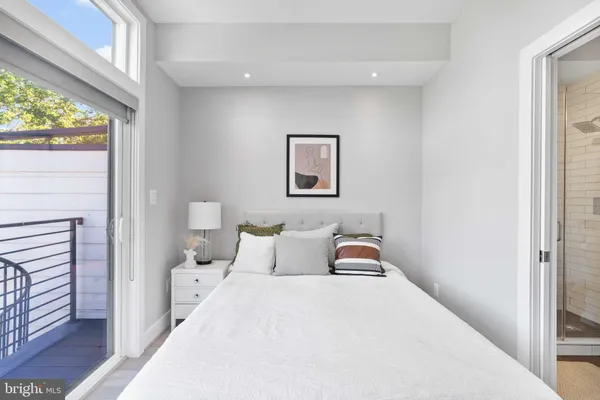 a bedroom with a bed and a large window