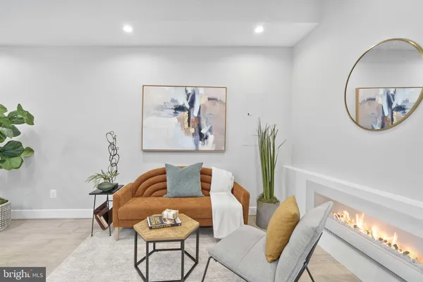 a living room with furniture and a potted plant