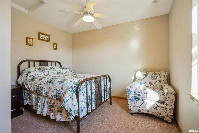 a bedroom with a bed and a fan