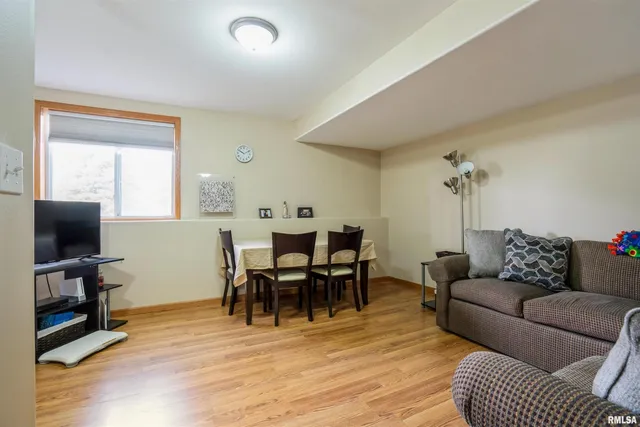 a living room with furniture a wooden floor and a flat screen tv
