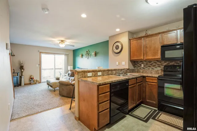 a kitchen with stainless steel appliances granite countertop a stove and a sink