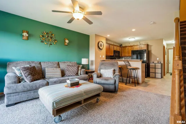 a living room with furniture and kitchen view