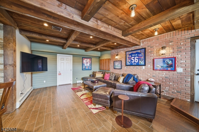 84 West Shore Road Denville, NJ 07834 - Photo 24 of 50 a living room with furniture and a flat screen tv