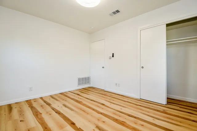 a view of a room with wooden floor