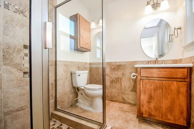 a bathroom with a toilet and a shower