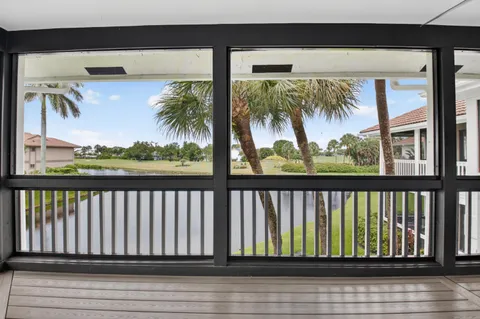 a view of a hallway view with wooden floor and living room