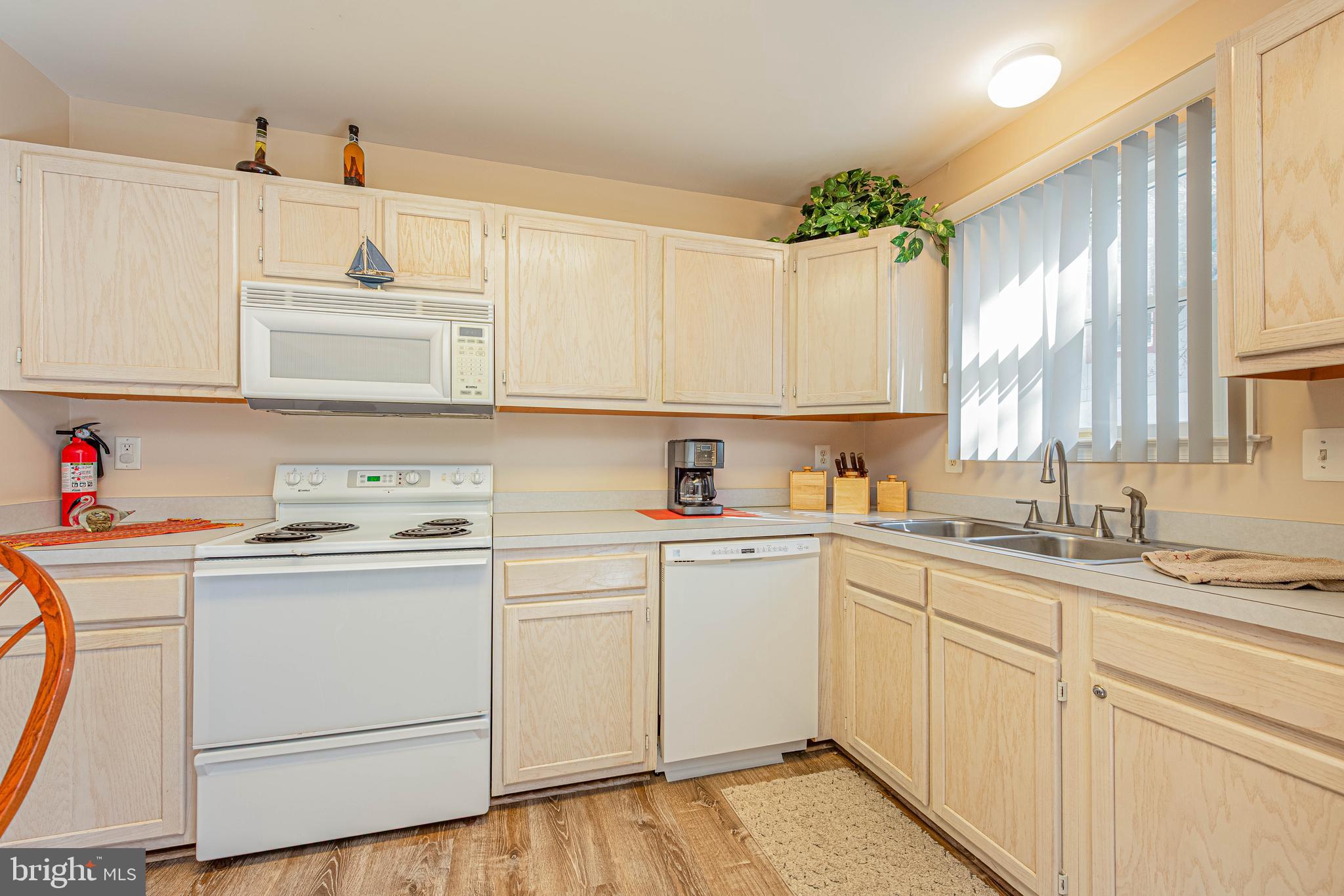 135 Captains Quarters Road Ocean City, MD 21842 - Photo 11 of 27 a kitchen with cabinets appliances a sink and a window