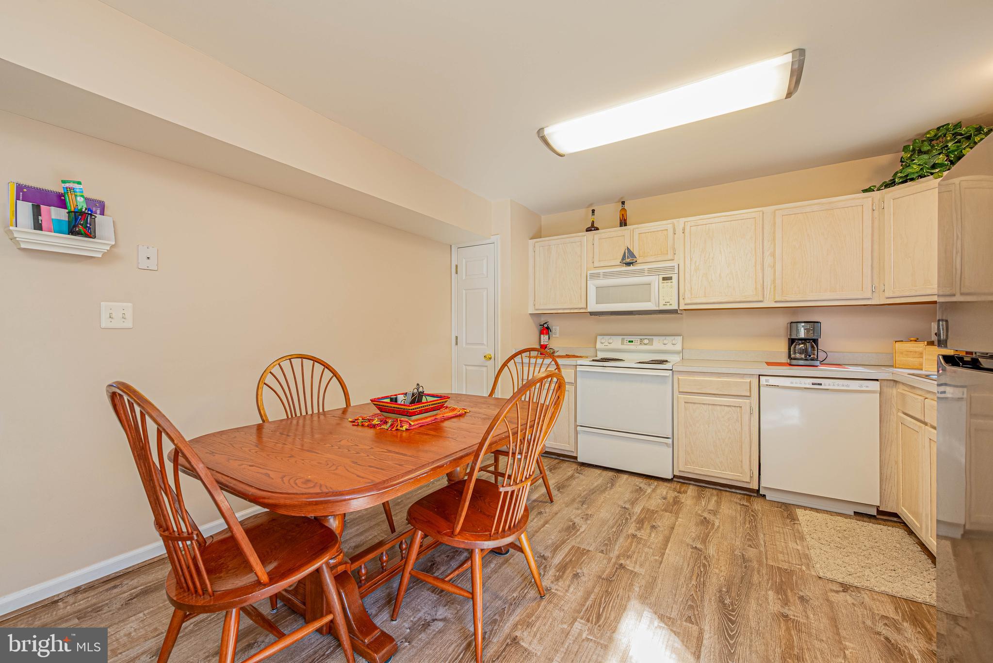 135 Captains Quarters Road Ocean City, MD 21842 - Photo 14 of 27 a kitchen with a white table chairs and white cabinets