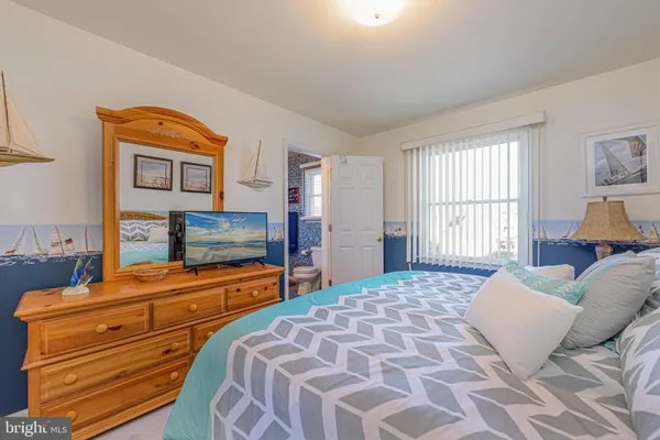 a bedroom with a bed and a television