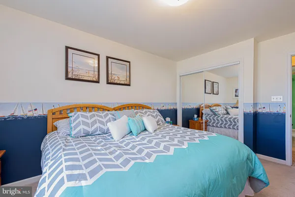 a bedroom with a large bed and a dresser