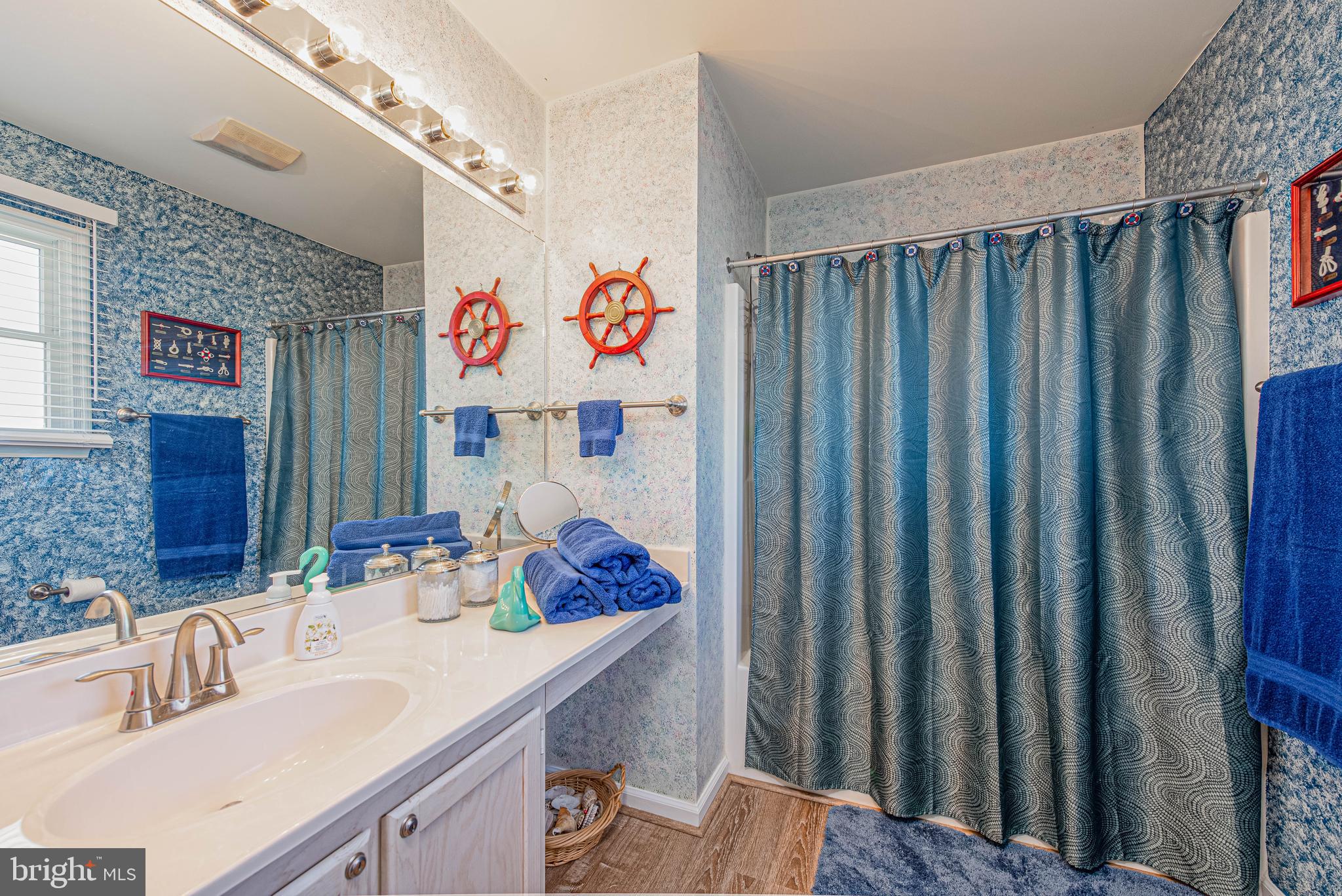 135 Captains Quarters Road Ocean City, MD 21842 - Photo 20 of 27 a bathroom with sink and mirror