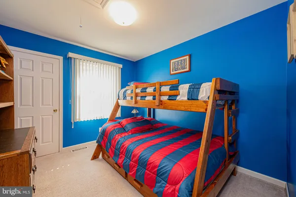 a bedroom with a bed and dresser
