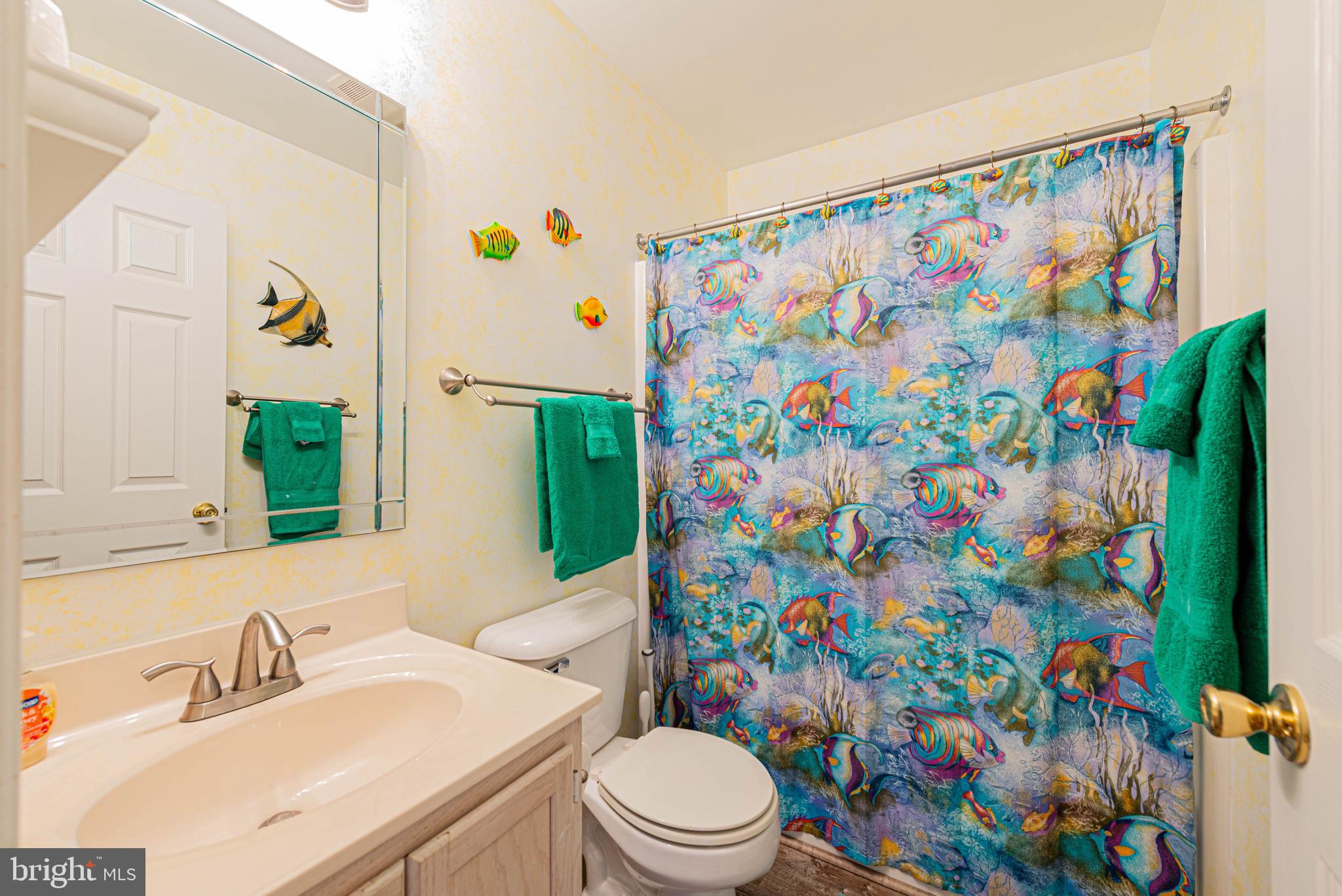 135 Captains Quarters Road Ocean City, MD 21842 - Photo 25 of 27 a bathroom with a sink a toilet and a curtain