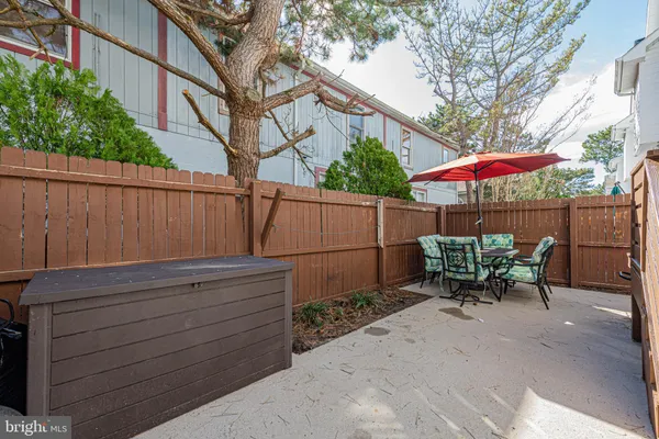 a view of a outdoor sitting area with furniture and umbrella