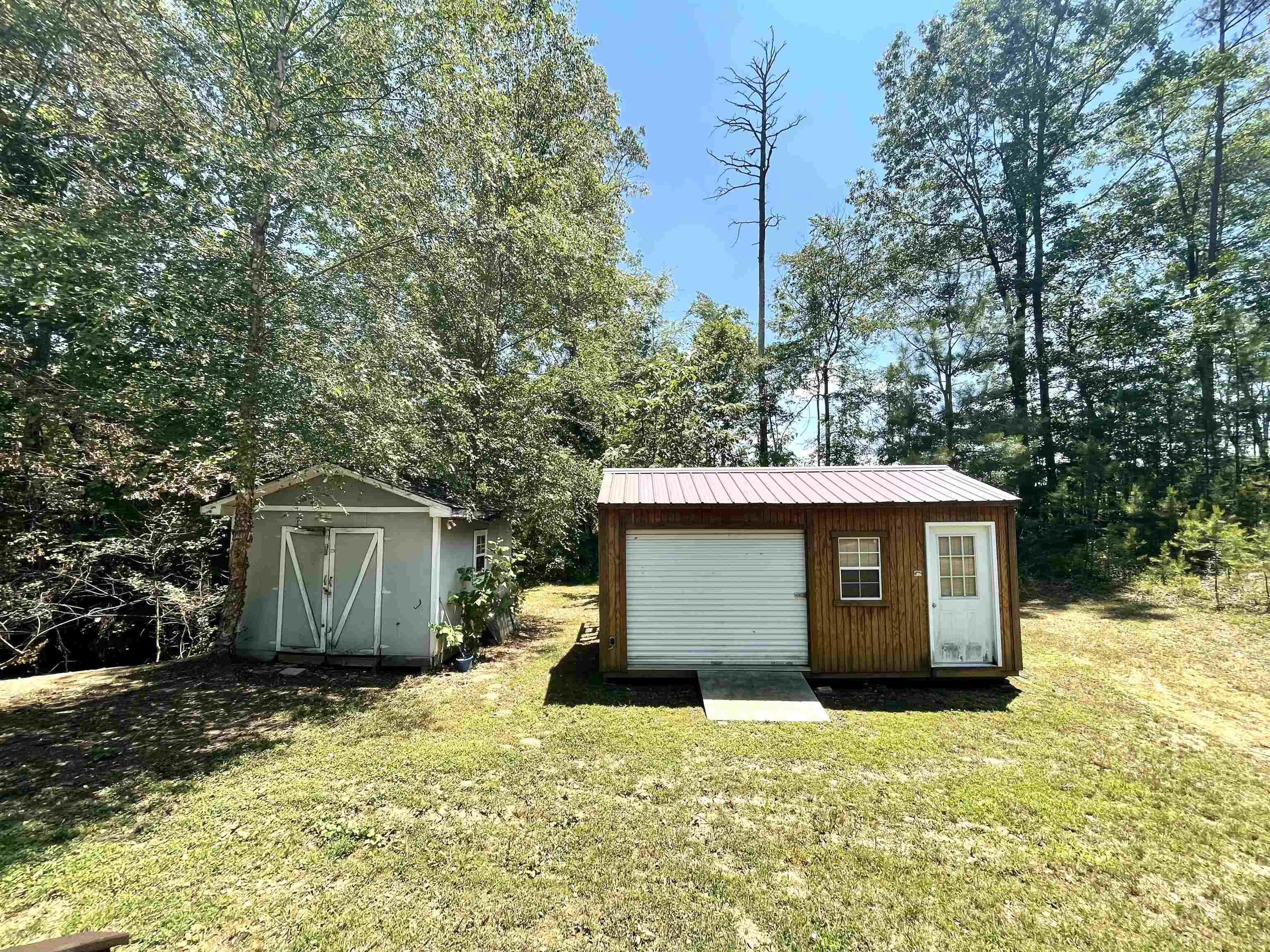 131 Wayne Elam Road Ramer, TN 38367 - Photo 14 of 15 a front view of a house with a yard and garage