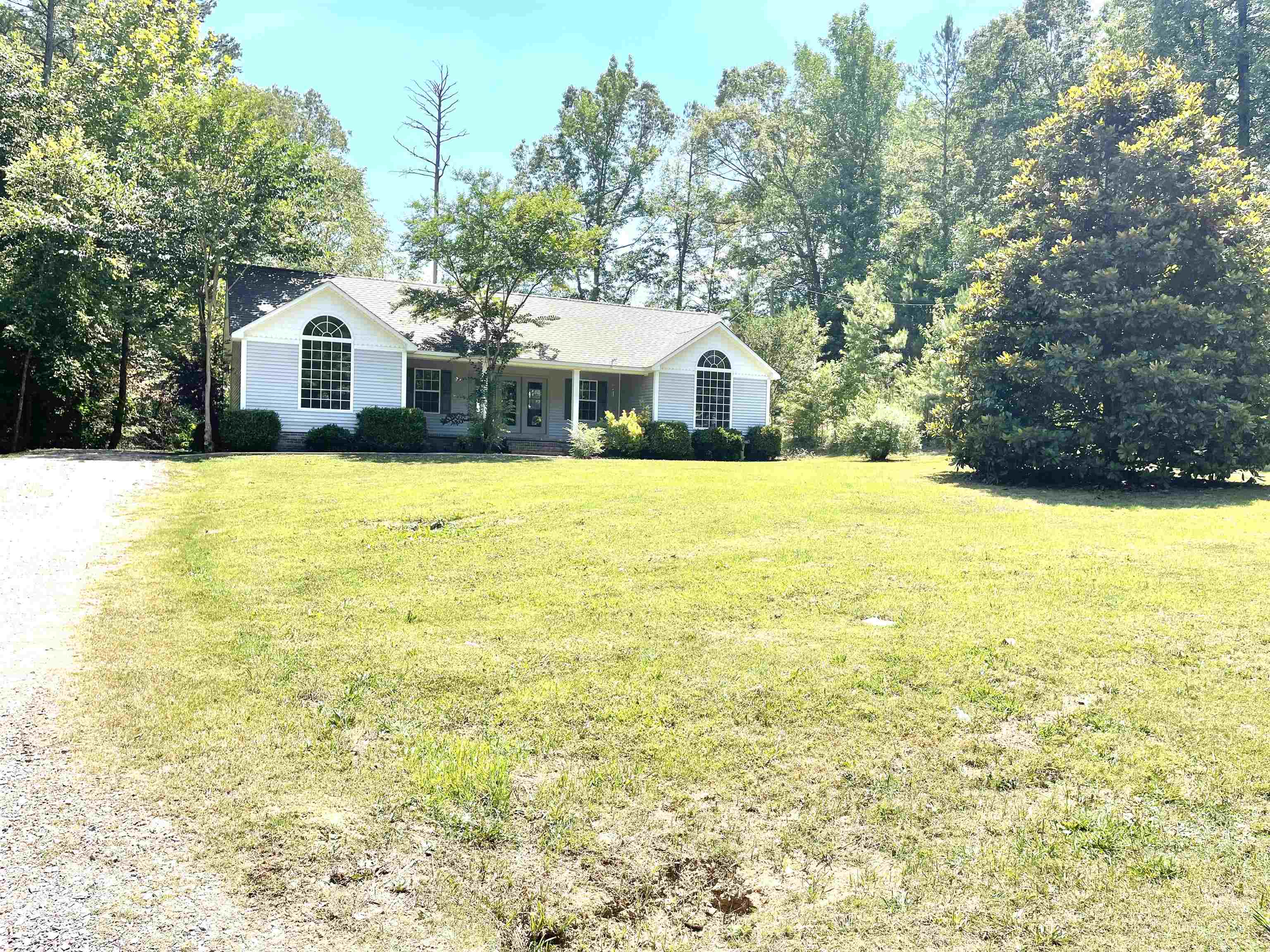 131 Wayne Elam Road Ramer, TN 38367 - Photo 2 of 15 a large white house with a large pool in front of it